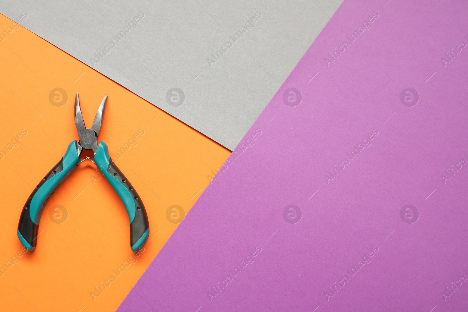 Photo of Bent nose pliers on color background, top view. Space for text