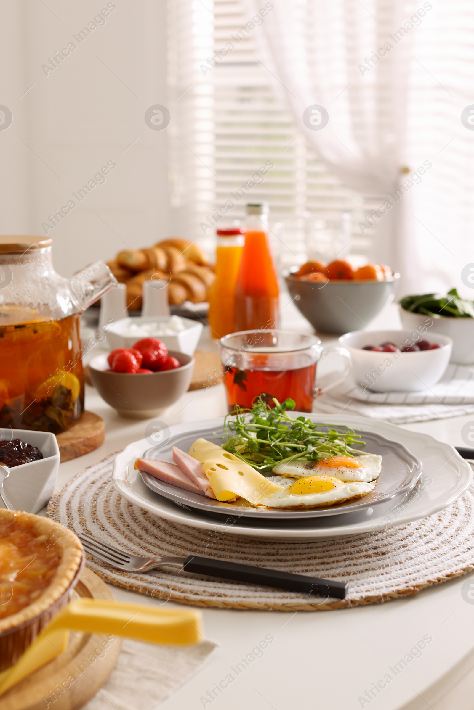 Photo of Fried eggs with sausage and cheese served on buffet table for brunch