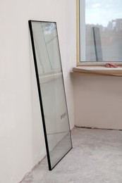 Photo of Double glazing window on floor near plasterboard wall indoors
