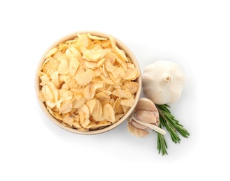 Bowl of dried garlic flakes and rosemary on white background, top view