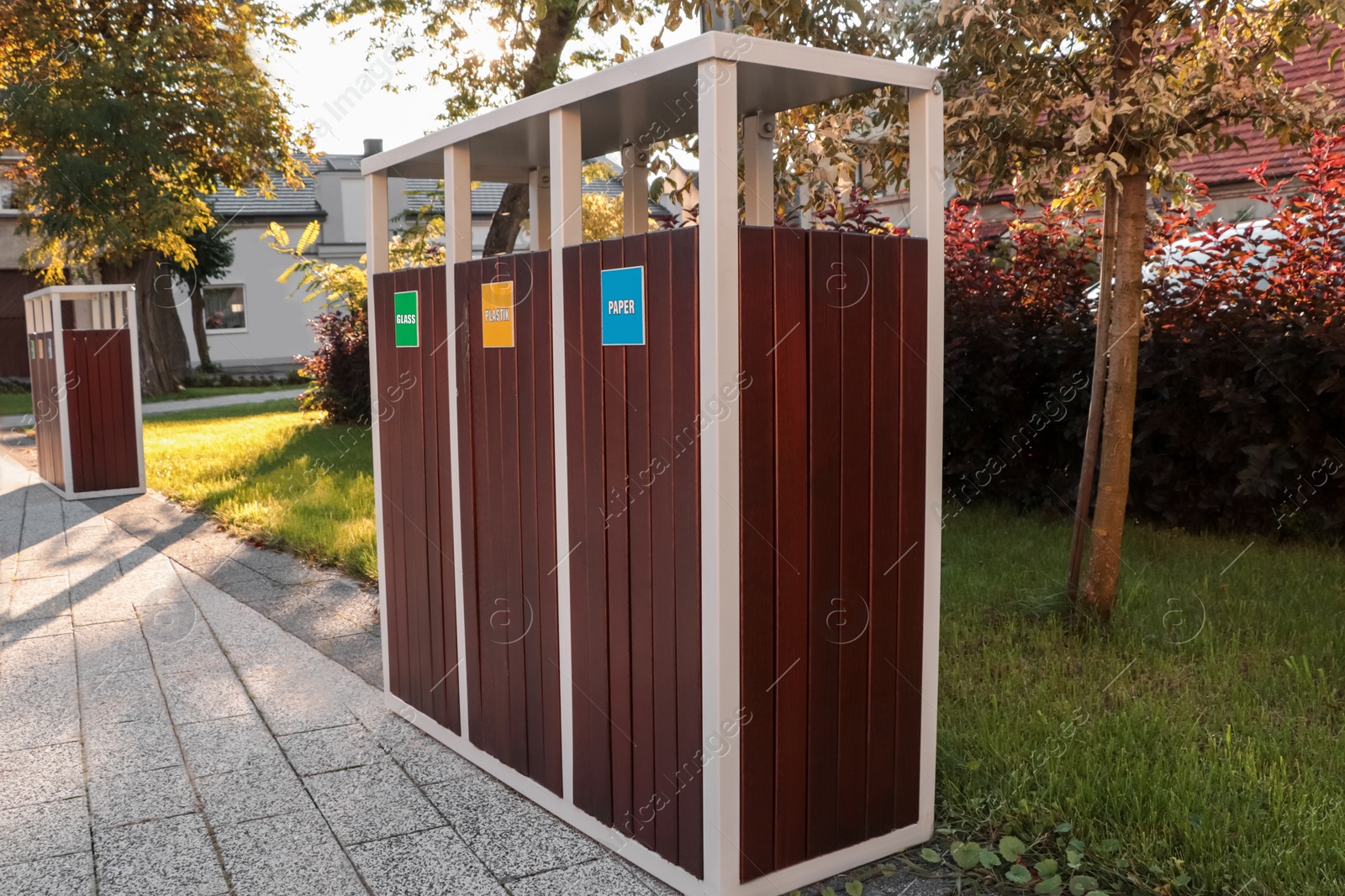 Photo of Different sorting bins for waste recycling on sunny day outdoors