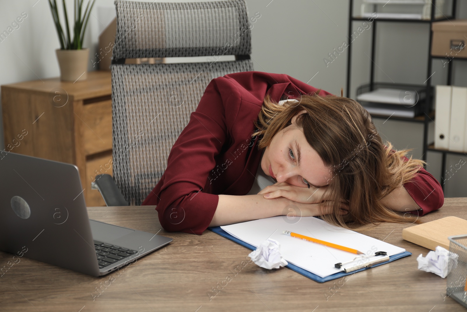 Photo of Sad businesswoman working at wooden table in office