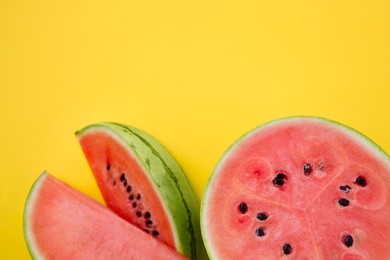 Photo of Delicious cut ripe watermelons on yellow background, flat lay. Space for text