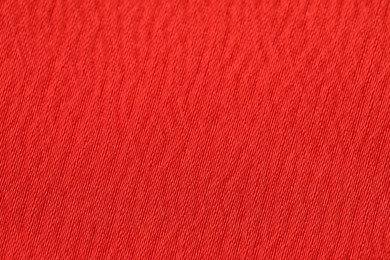 Photo of Texture of soft red fabric as background, top view