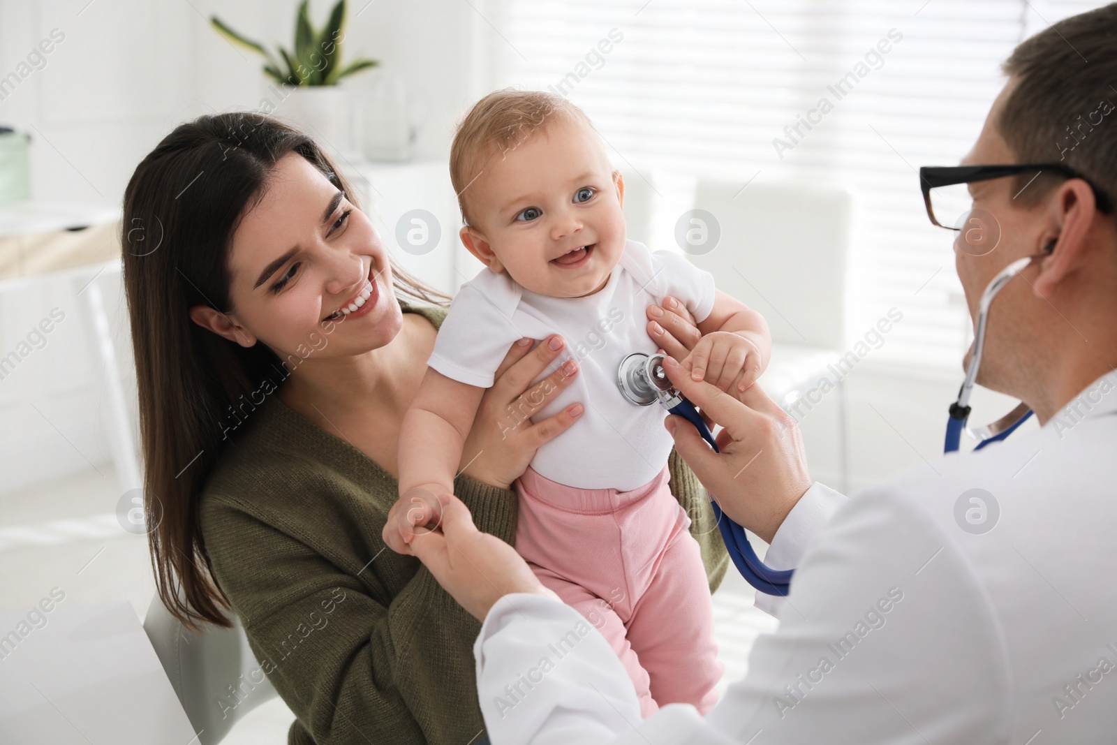 Photo of Mother with her cute baby visiting pediatrician in clinic