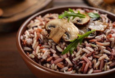 Photo of Delicious brown rice in bowl, closeup view