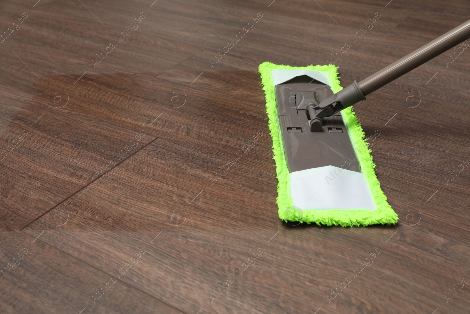 Photo of Cleaning of wooden floor with modern mop