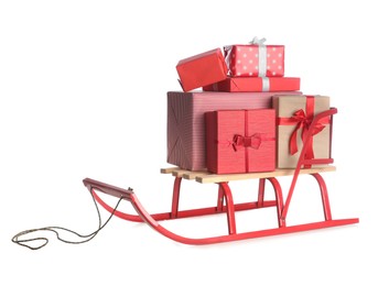 Photo of Sleigh with Christmas gifts on white background