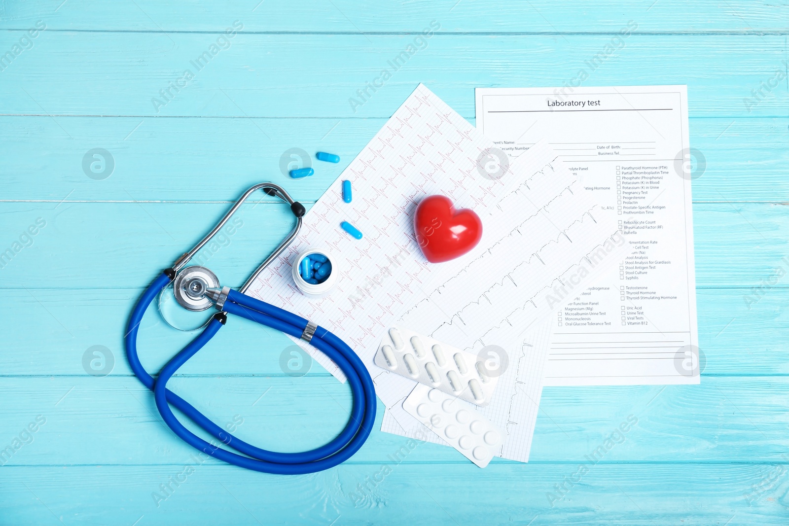 Photo of Flat lay composition with stethoscope and pills on wooden background. Cardiology service