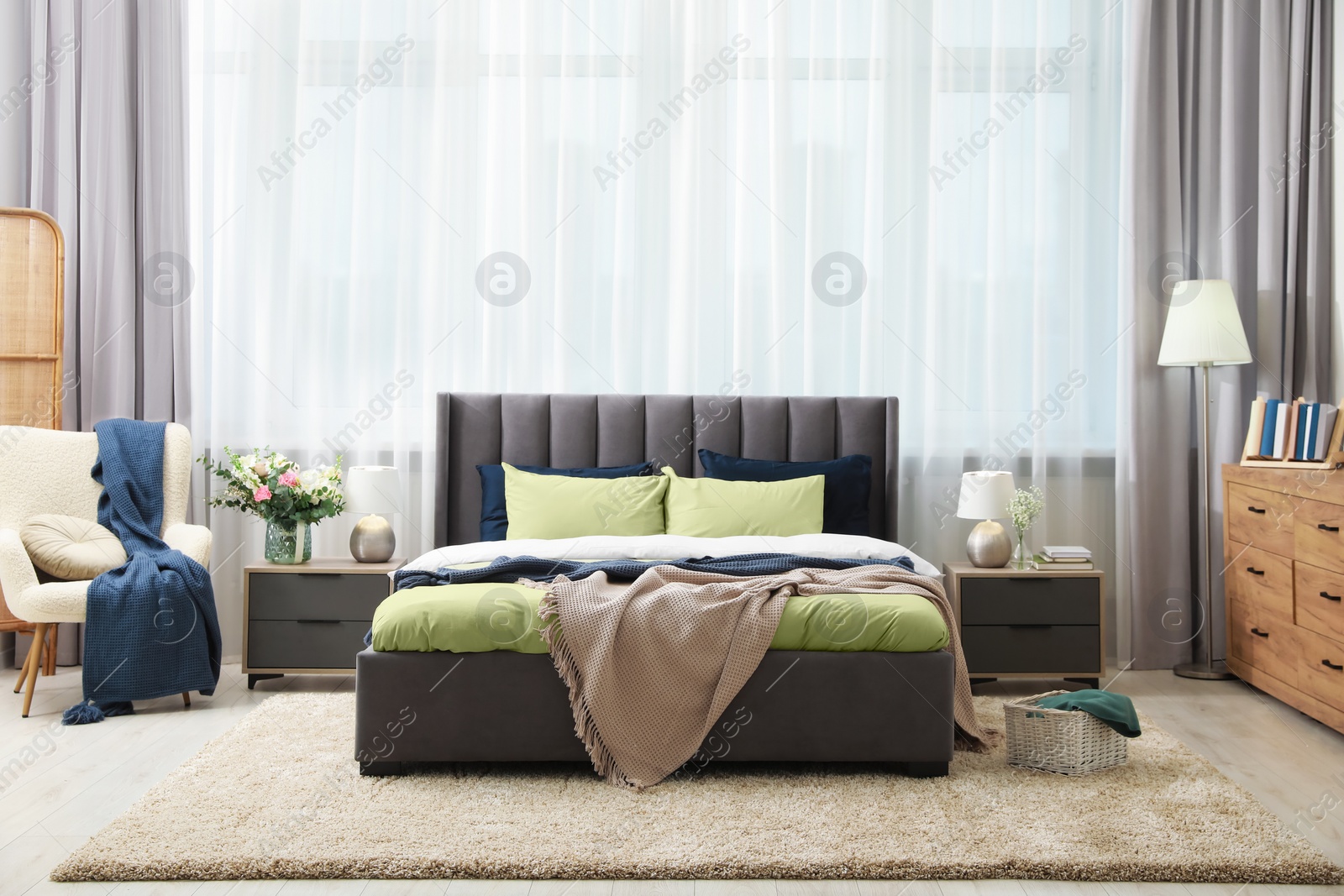 Photo of Stylish bedroom interior with large comfortable bed