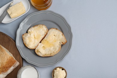 Photo of Sandwiches with butter, honey and milk on light grey table, flat lay. Space for text