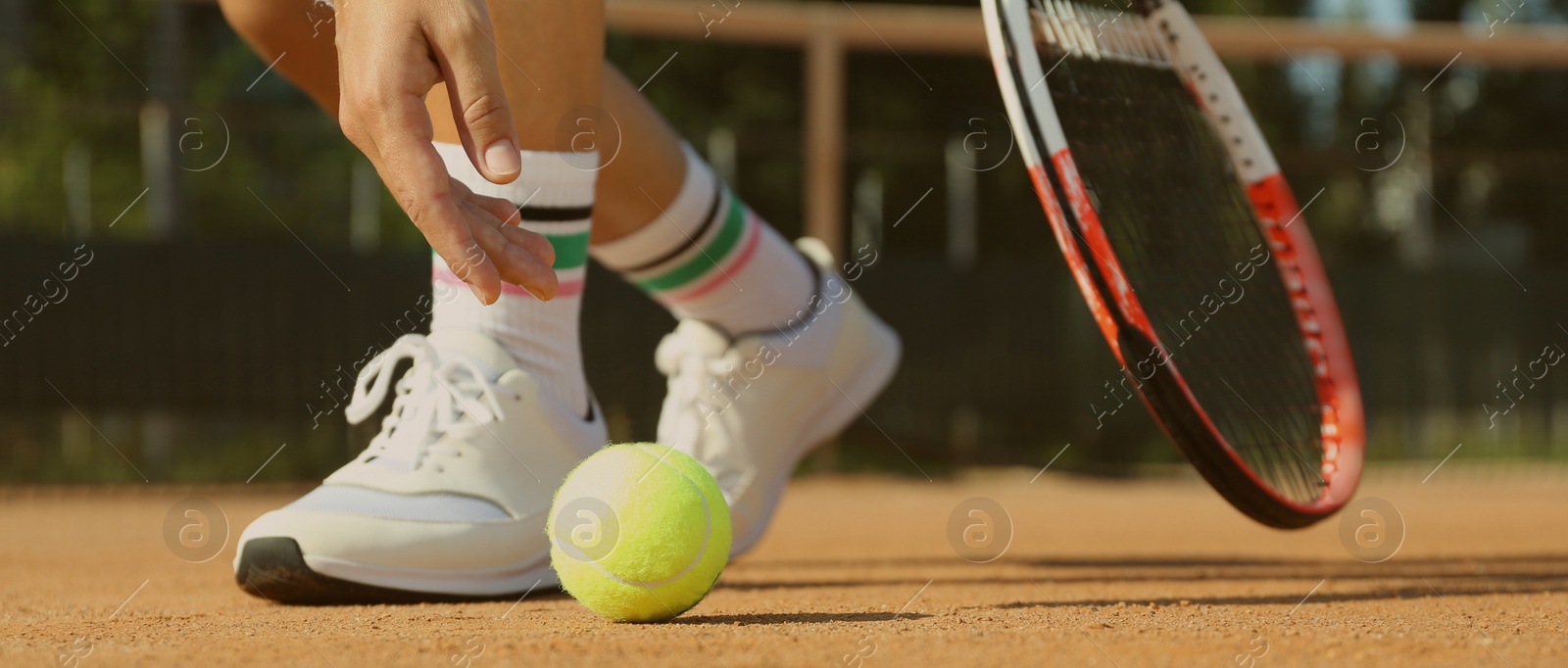 Image of Sportswoman playing tennis at court on sunny day, closeup. Banner design