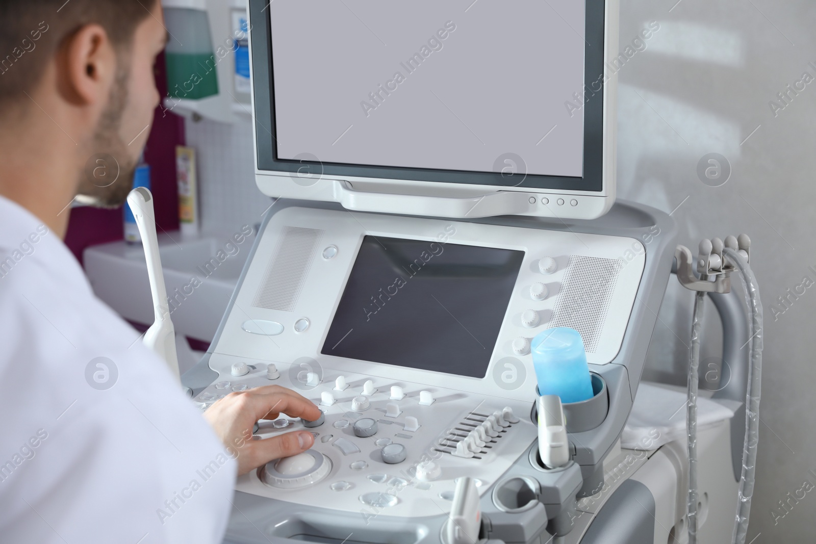 Photo of Sonographer using modern ultrasound machine in clinic