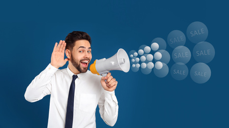 Image of Young man with megaphone on blue background