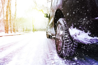 Image of Modern car with winter tires on snowy road