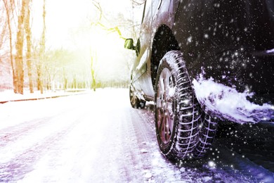 Modern car with winter tires on snowy road