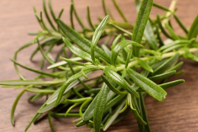 Fresh green rosemary on wooden table, closeup