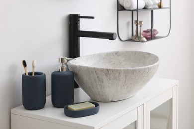Photo of Different bath accessories, personal care products and bathroom vanity indoors