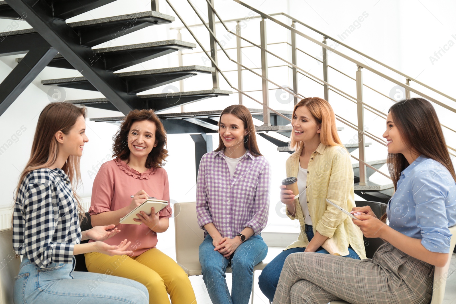 Photo of Cheerful ladies at meeting indoors. Women power concept