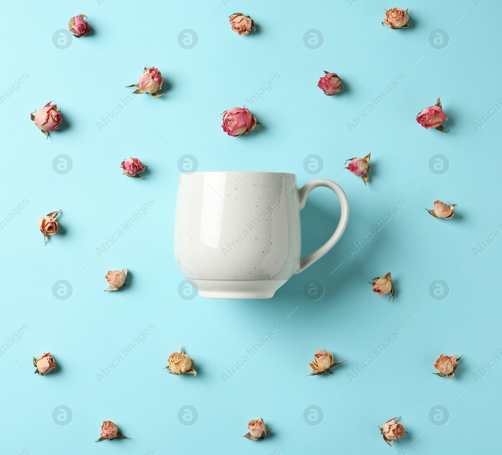 Photo of Flat lay composition with teacup and dried roses on color background