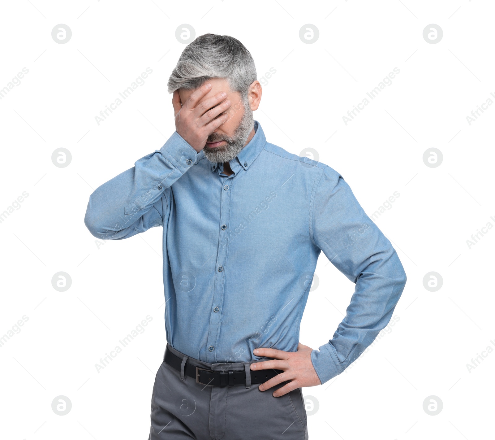 Photo of Mature businessman covering face with hand on white background