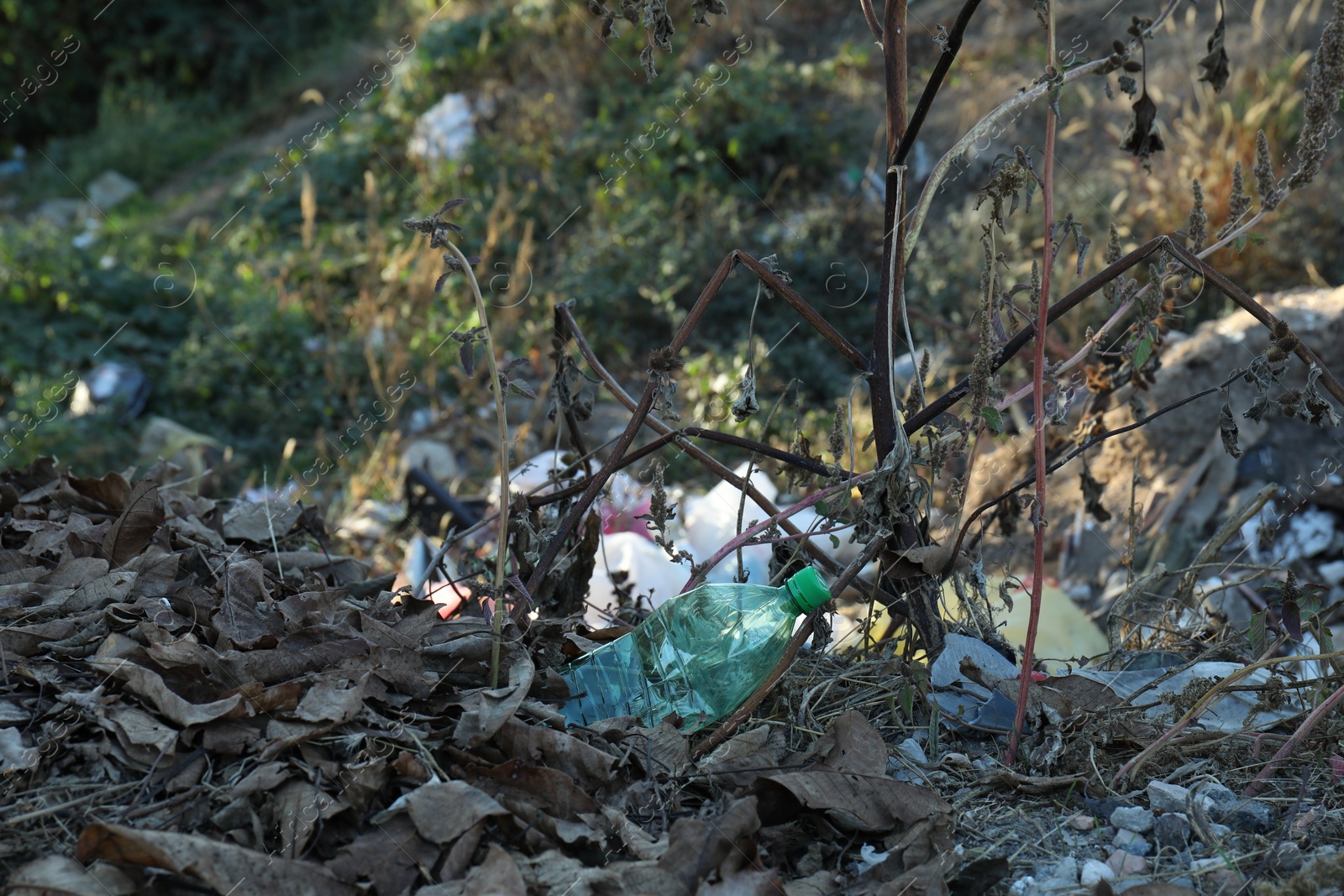 Photo of Different plastic garbage outdoors. Environmental pollution concept