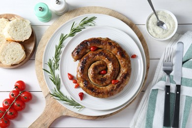 Tasty homemade sausages served on white wooden table, flat lay