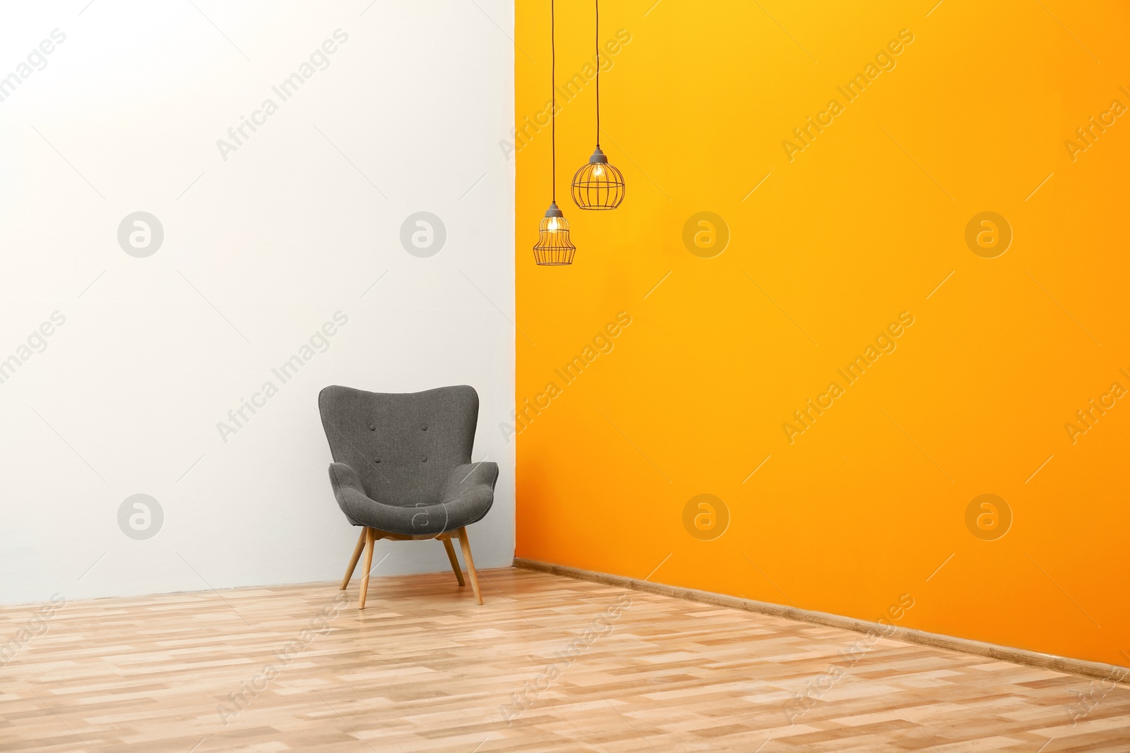 Photo of Living room interior with comfortable armchair near color wall