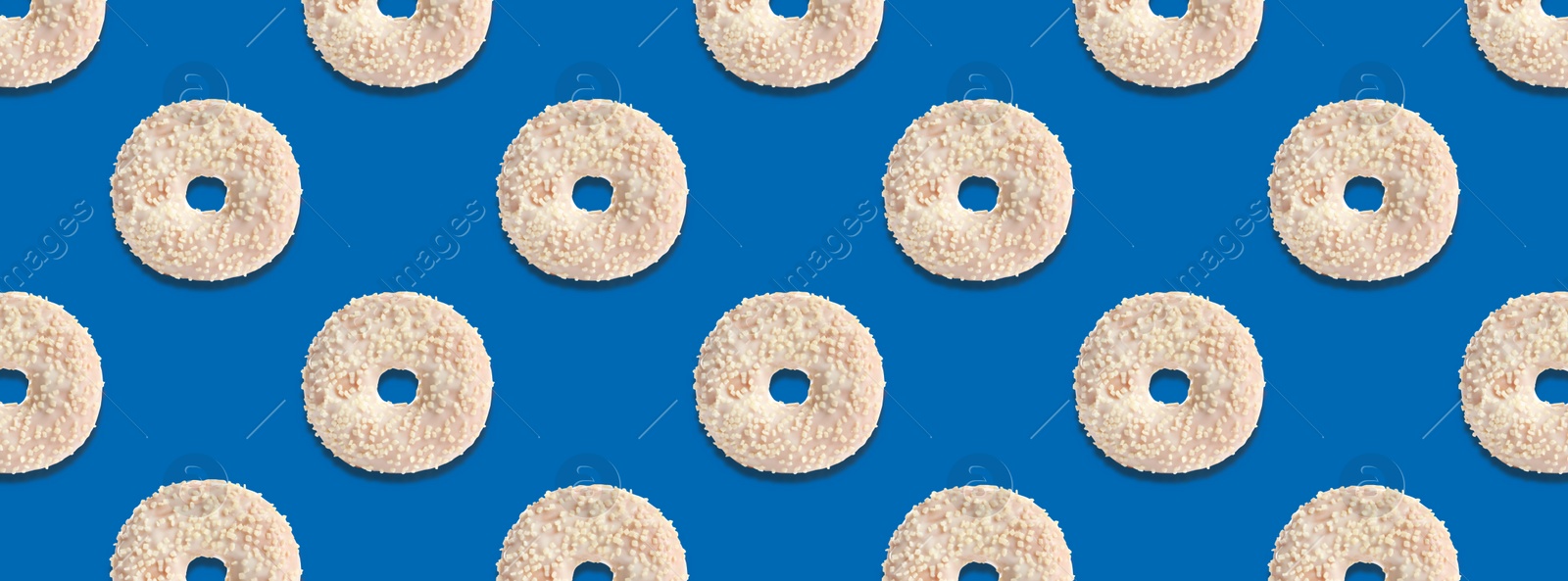 Image of Creative pattern design of glazed donuts on blue background, banner