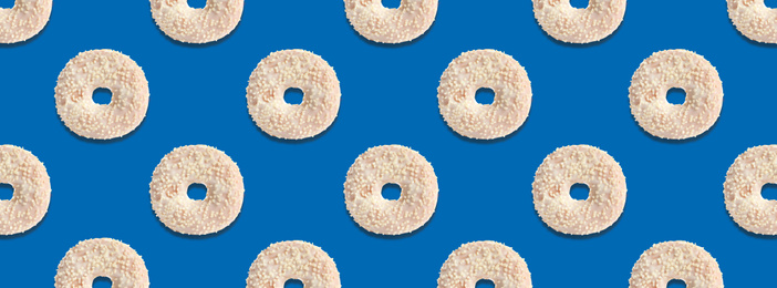 Image of Creative pattern design of glazed donuts on blue background, banner