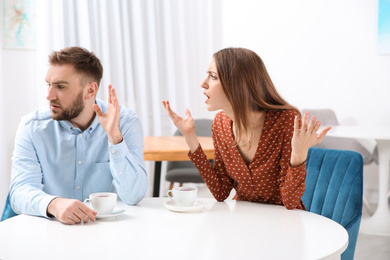 Couple having quarrel in cafe. Relationship problems