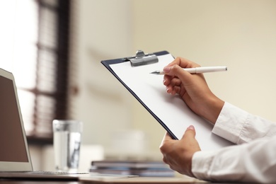 Business trainer working at table in office, closeup