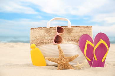 Photo of Different stylish beach objects and starfishes on sand near sea