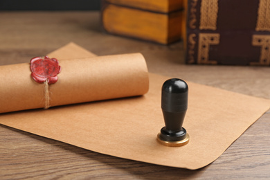 Notary's public pen and sealed document on wooden table