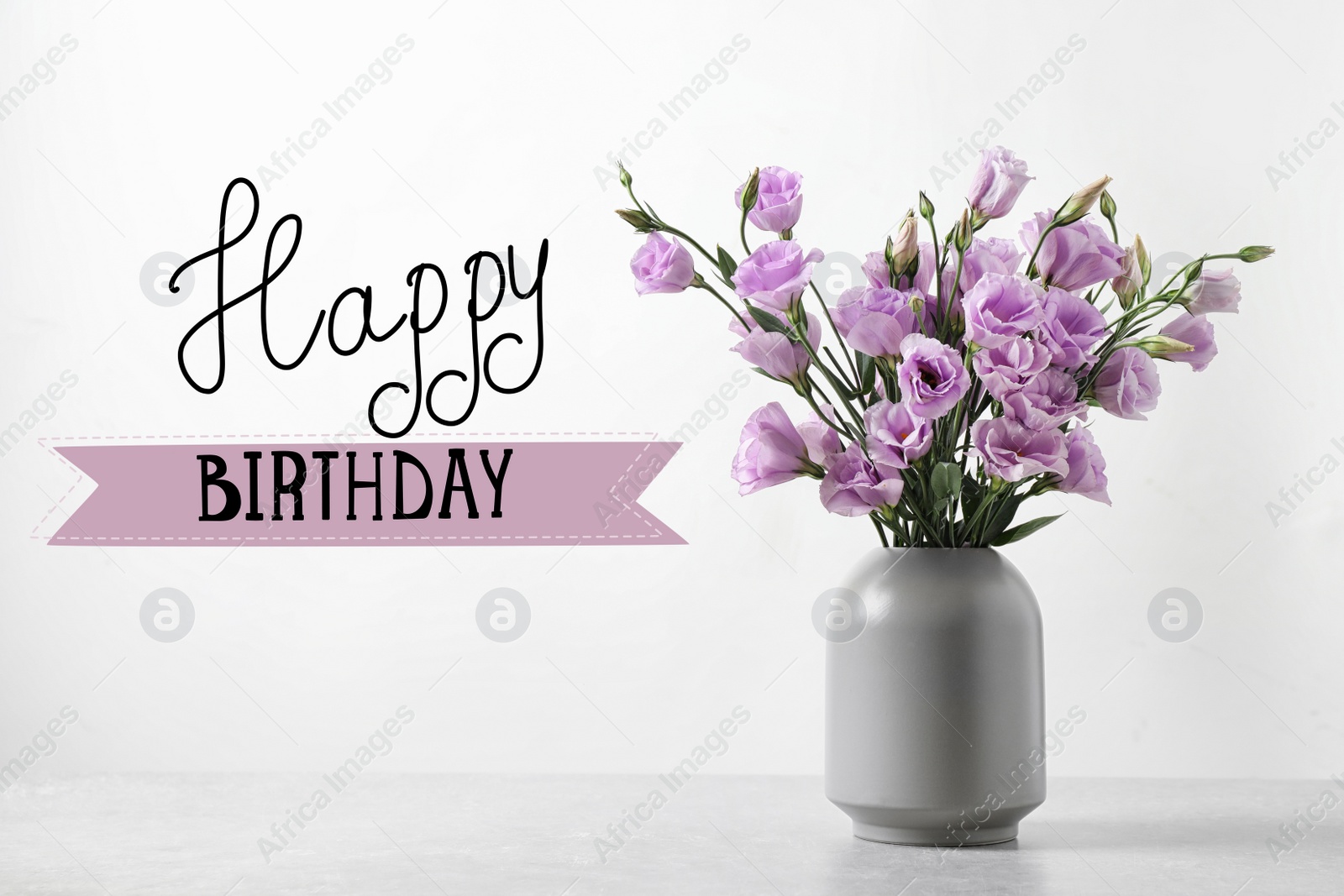 Image of Happy Birthday! Eustoma flowers in vase on table near white wall 