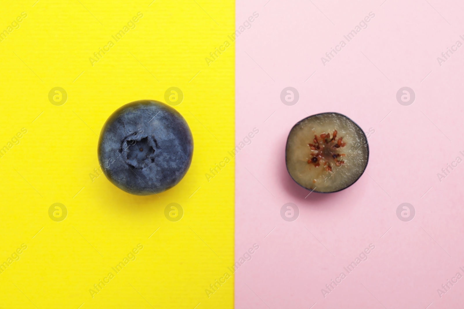 Photo of Flat lay composition with tasty blueberry on color background