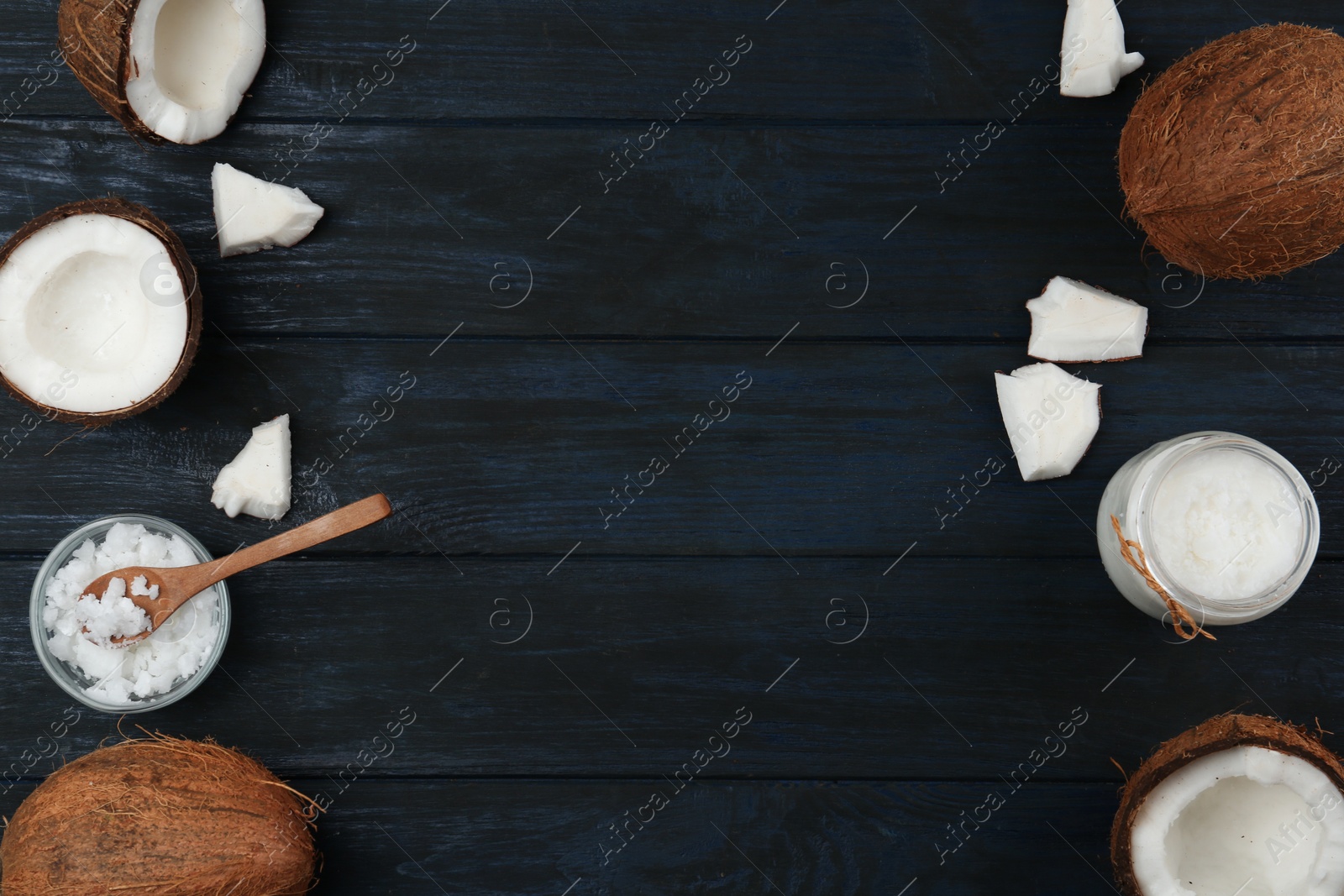 Photo of Flat lay composition with coconut oil on dark wooden table, space for text. Cooking ingredients