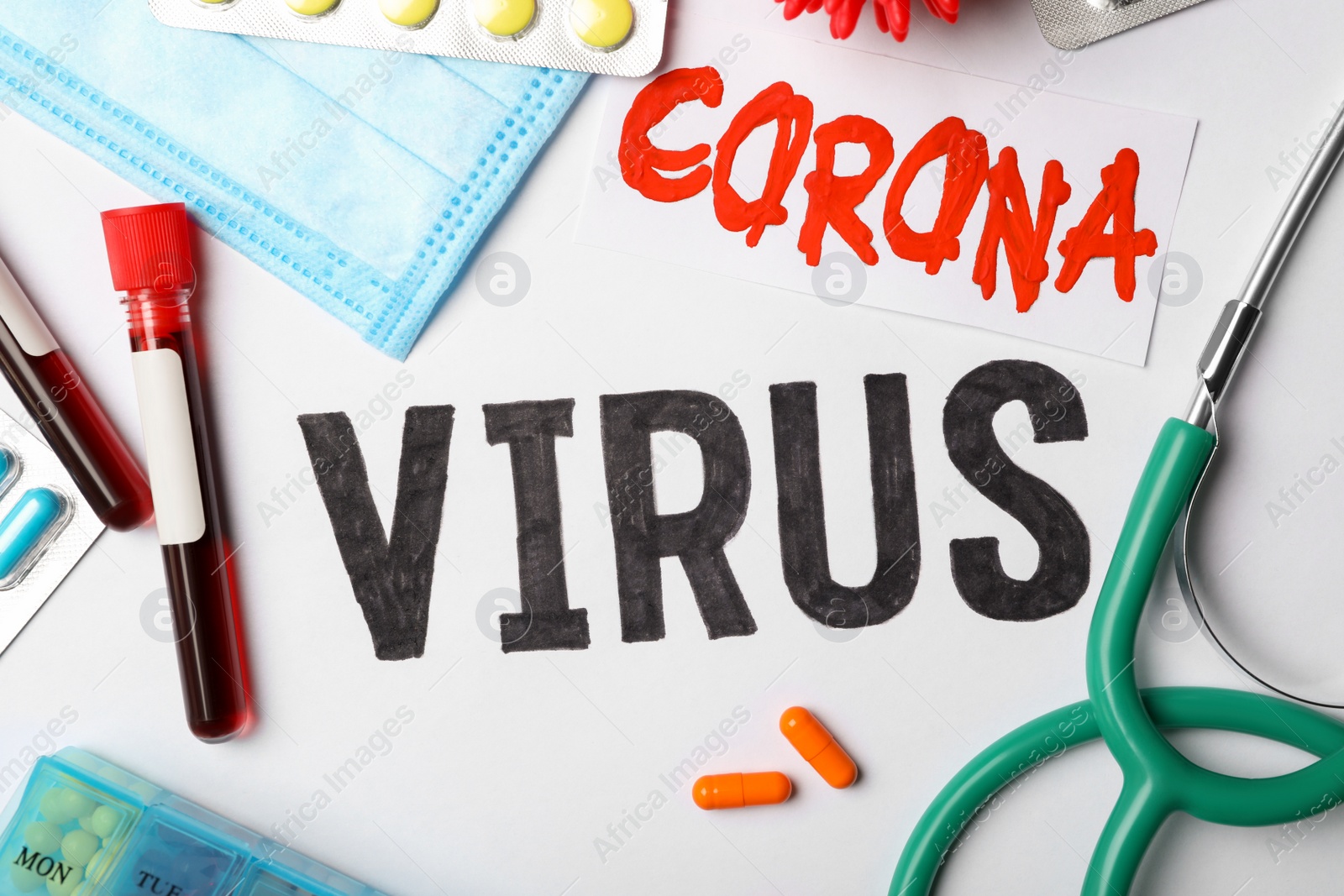 Photo of Flat lay composition with phrase CORONA VIRUS and medicines on white background