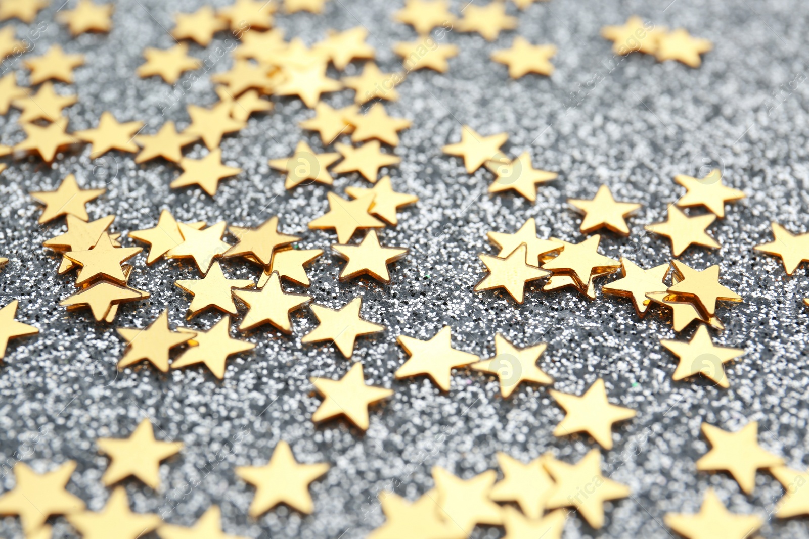 Photo of Confetti stars on grey background, closeup. Christmas celebration