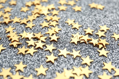 Confetti stars on grey background, closeup. Christmas celebration