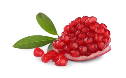 Piece of ripe juicy pomegranate and green leaves on white background