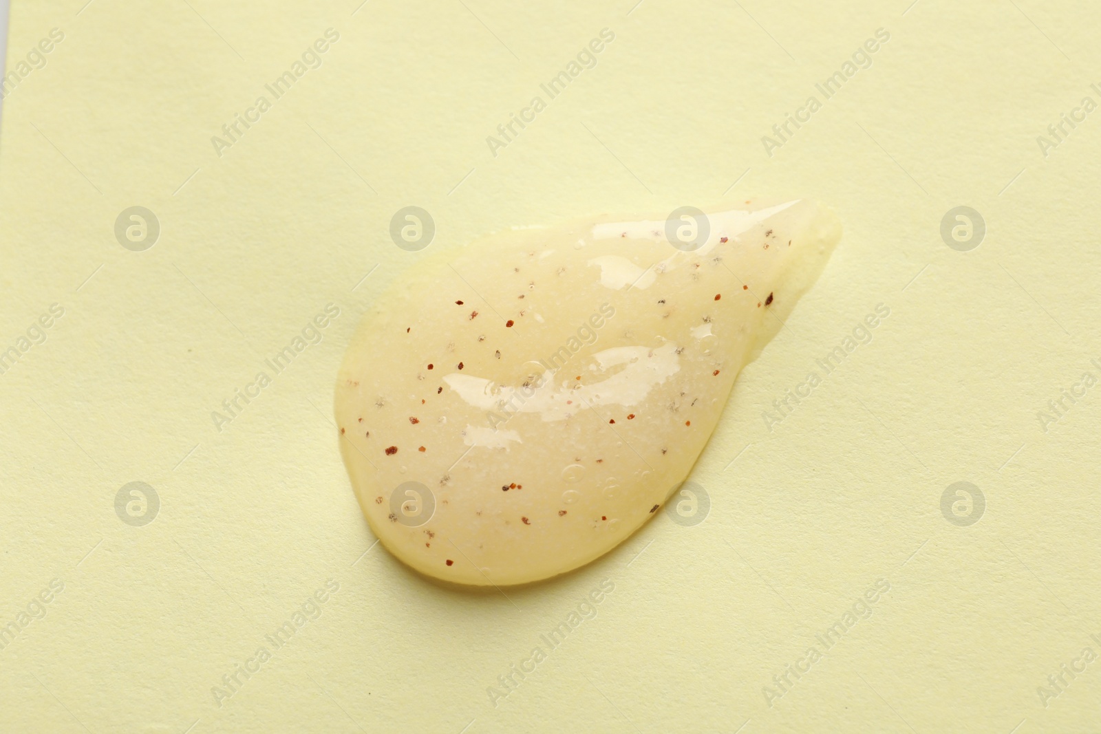 Photo of Sample of scrub on yellow background, top view