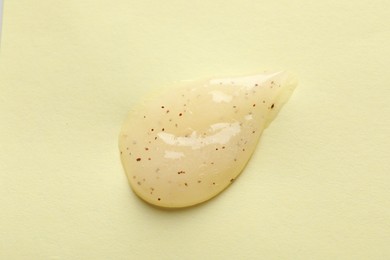 Photo of Sample of scrub on yellow background, top view