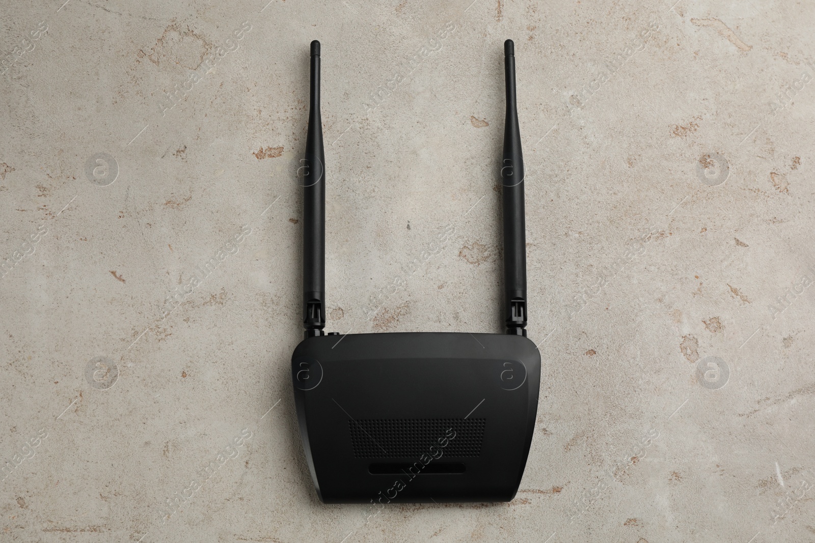 Photo of Modern Wi-Fi router on light background, top view