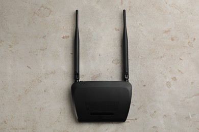 Photo of Modern Wi-Fi router on light background, top view