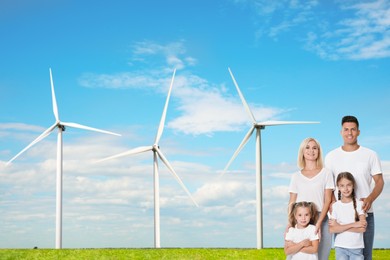 Image of Happy family with children and view of wind energy turbines on sunny day