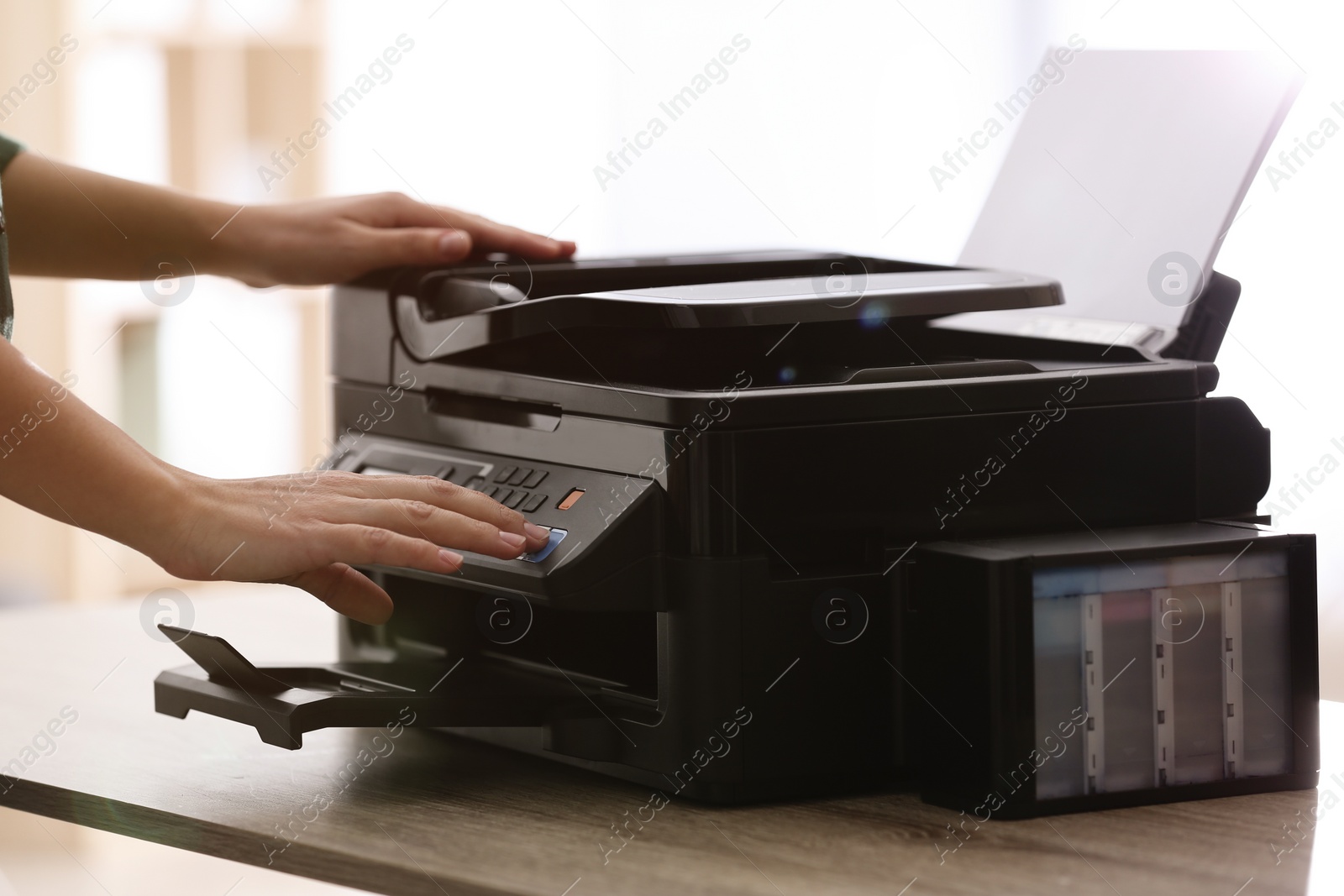 Photo of Employee using modern printer in office, closeup