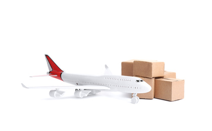 Airplane model and carton boxes on white background. Courier service