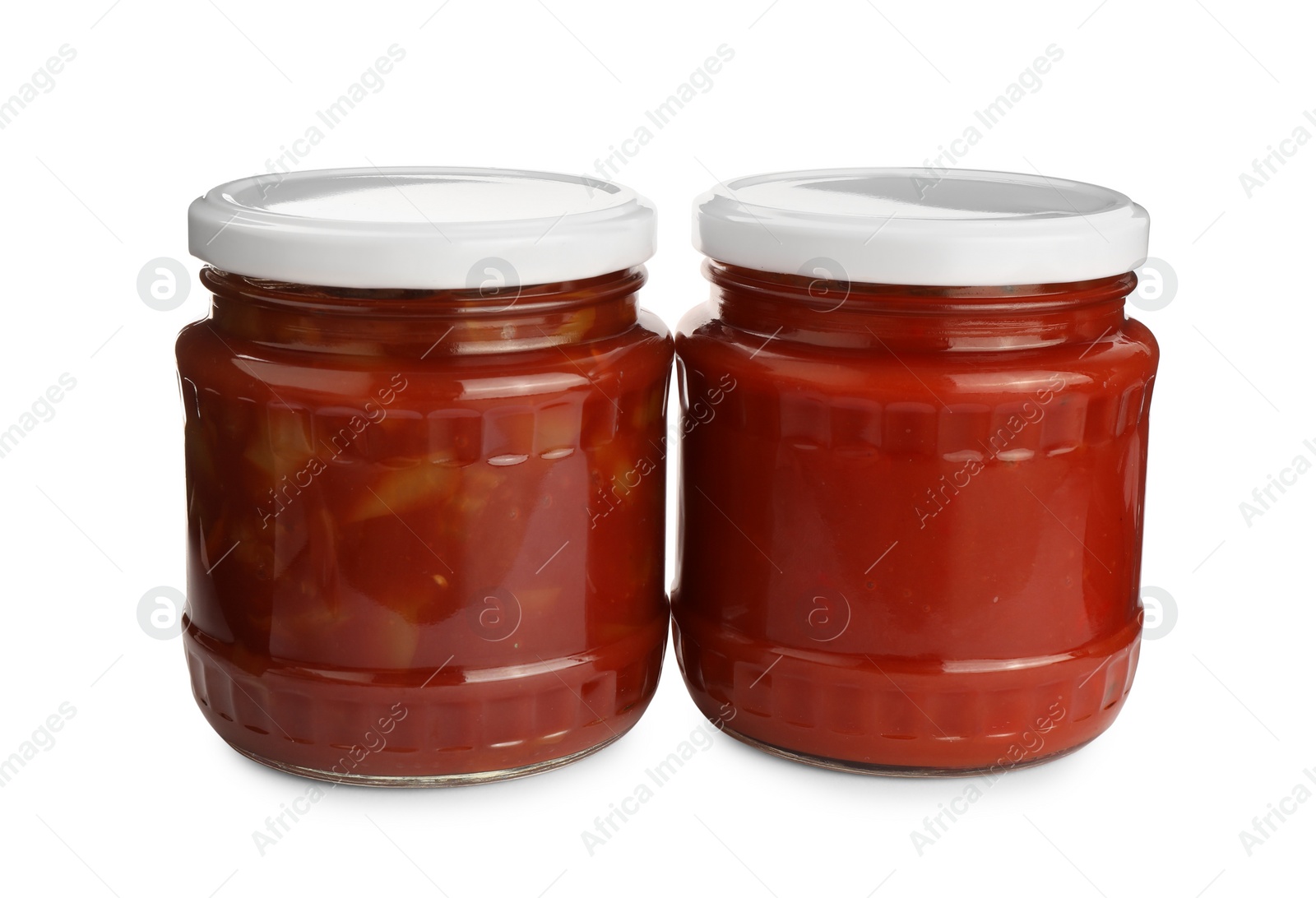 Photo of Glass jars of delicious canned lecho on white background