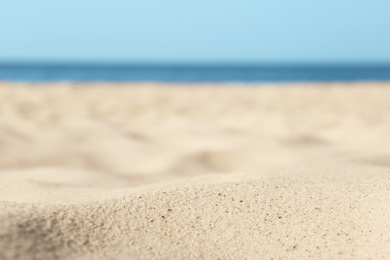 Photo of Beautiful sandy beach and sea on sunny day, closeup. Summer vacation